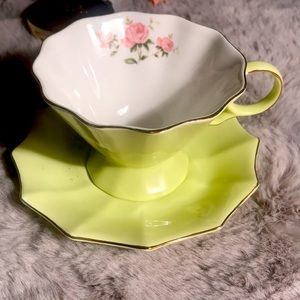 Lime yellow color tea cup and saucer with flower detail on inside.  Super cute